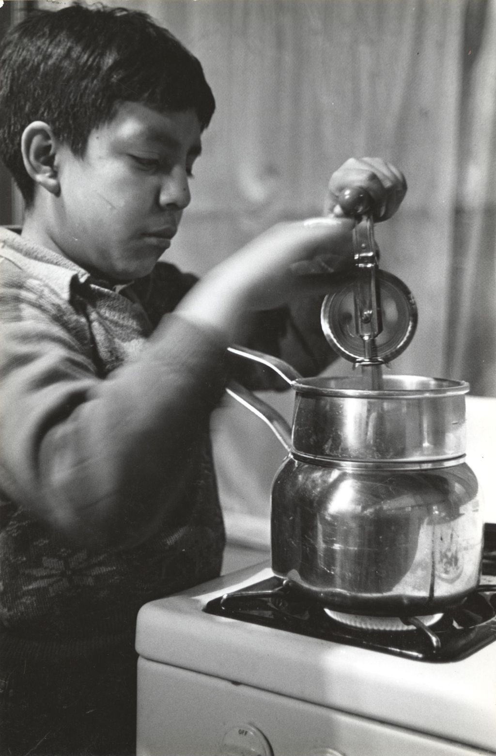 Miniature of Boy with hand mixer at stove in cooking class