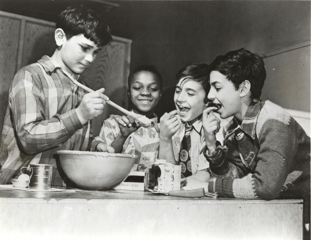Boys tasting frosting in cooking class