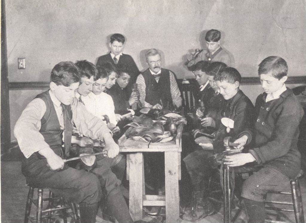 Boys in cobbling class with instructor