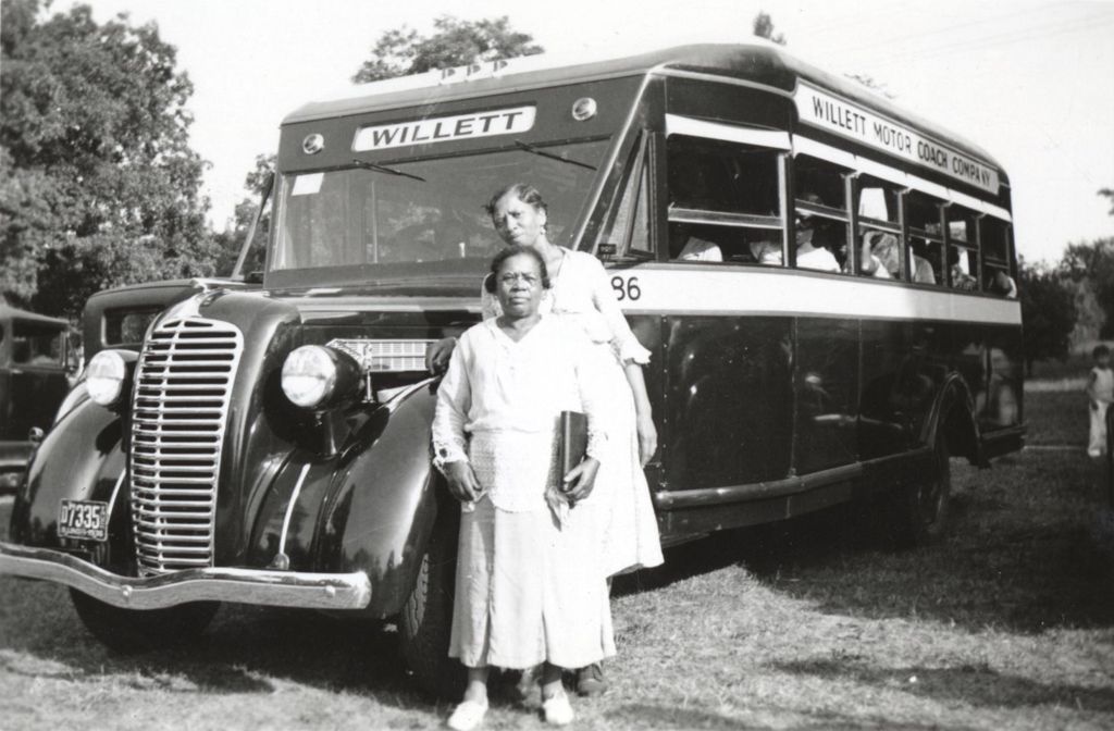 Two Hull-House Community Club members in front of a bus at Bowen Country Club
