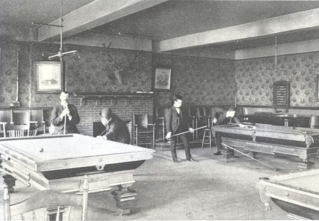 Men playing billiards in Hull-House men's club room