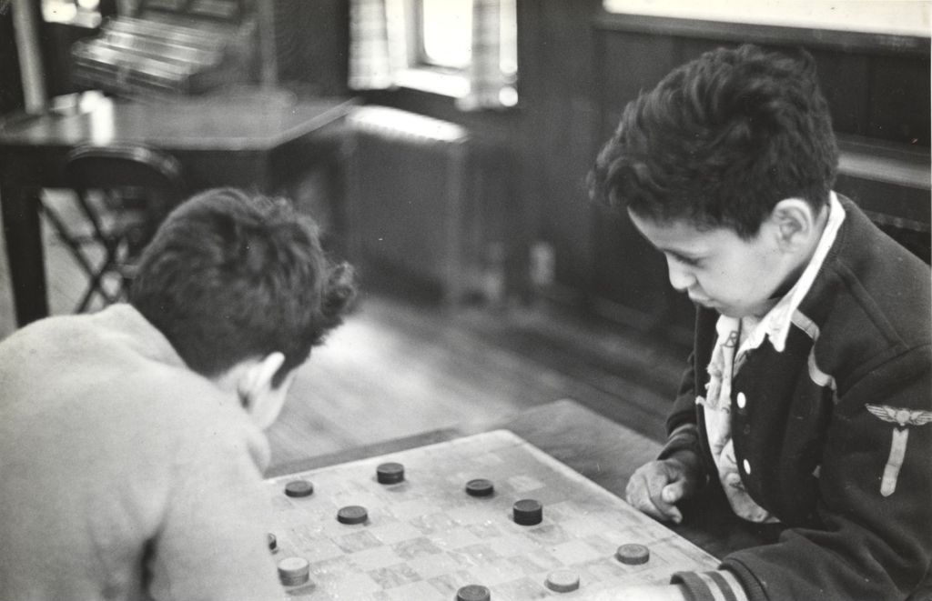 Two boys playing checkers