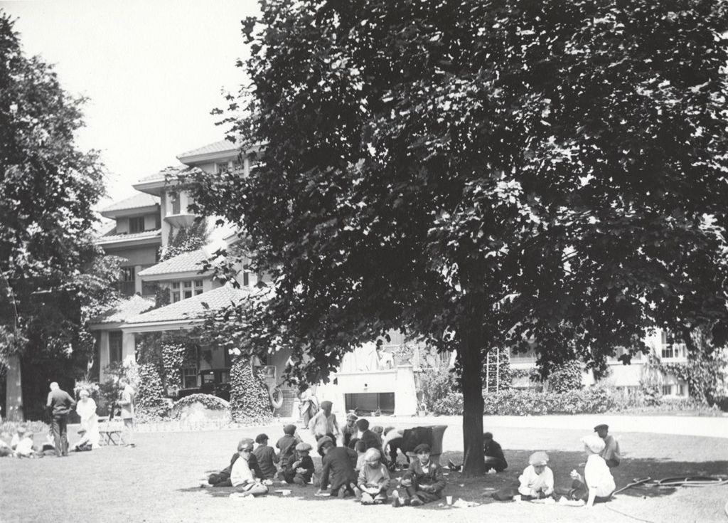 Miniature of A group of boys sitting in the shade of a large tree at Pick Estate