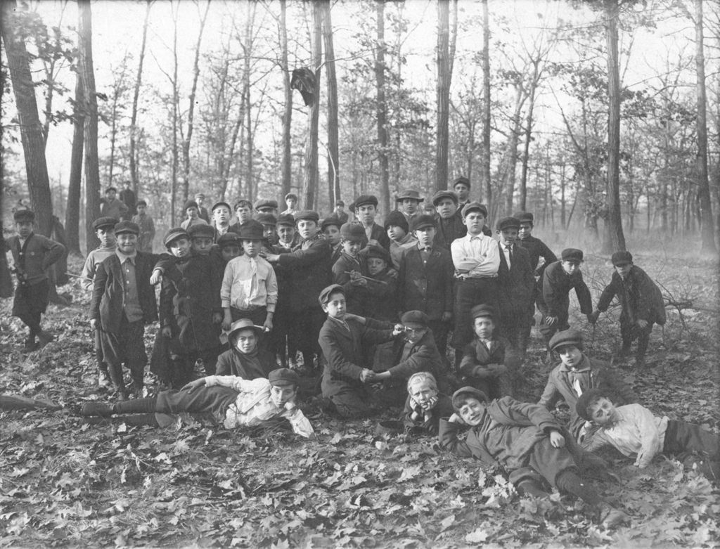 Large group of boys on outing in the woods