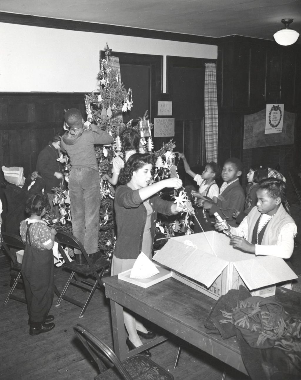Miniature of Children and adults decorating a Christmas tree