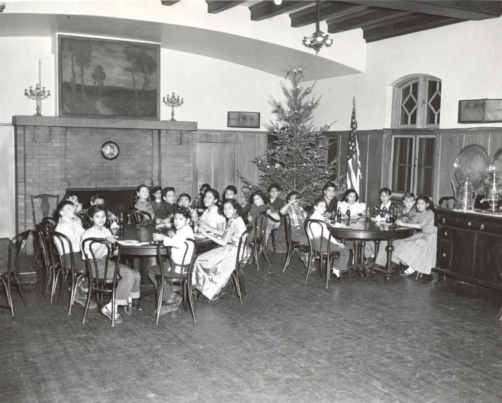 Young people sitting at tables at 1957 Hull-House Christmas party