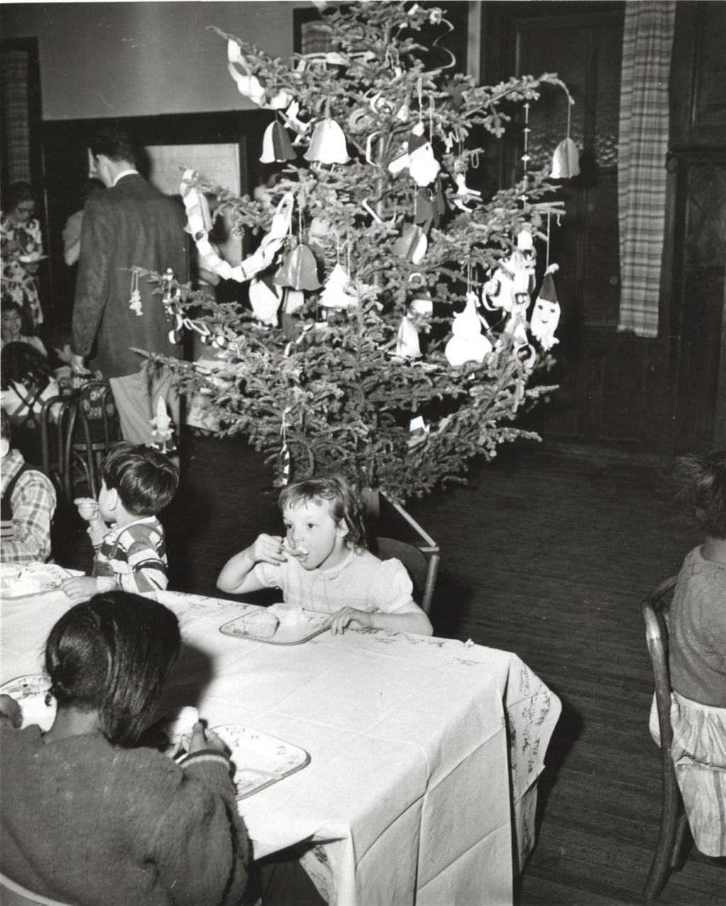 Children eating at tables during Hull-House Christmas party
