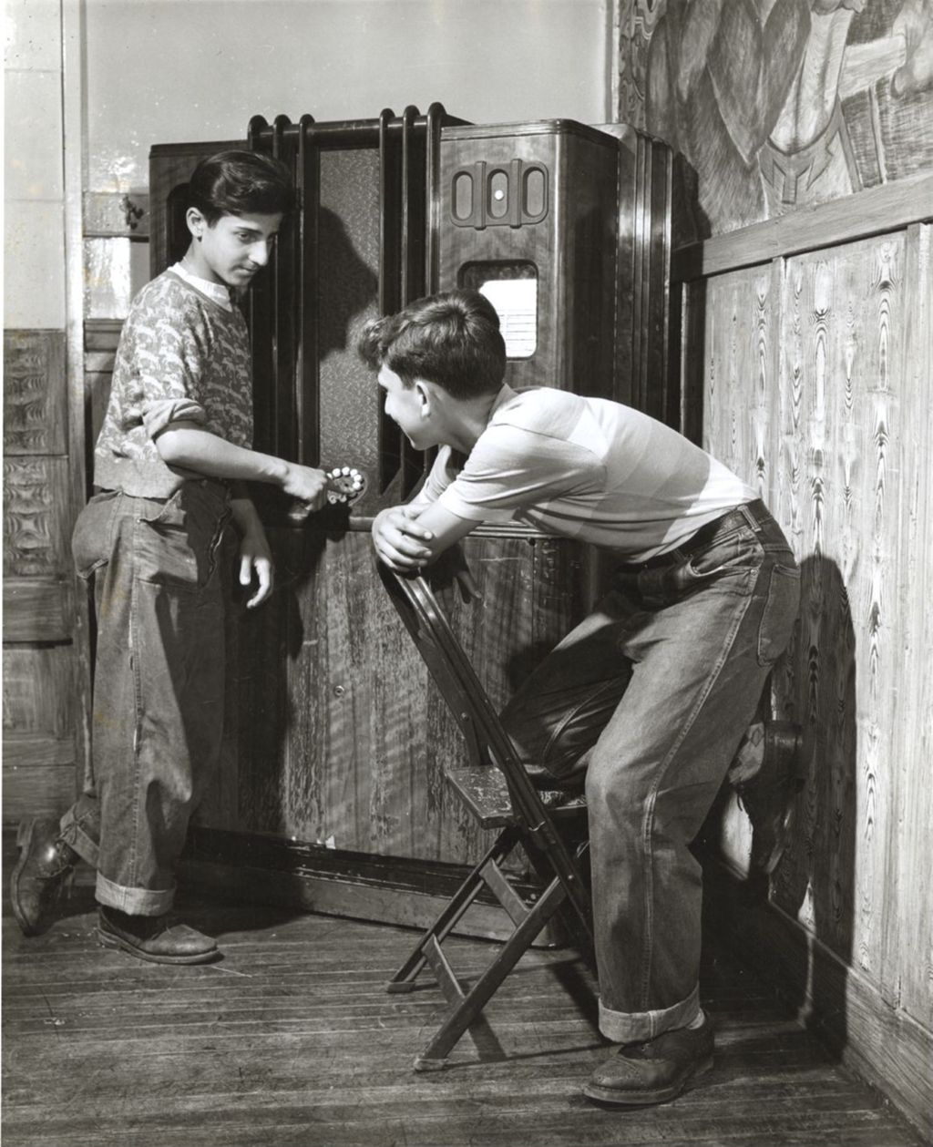 Two boys with jukebox in Hull-House boys' game room