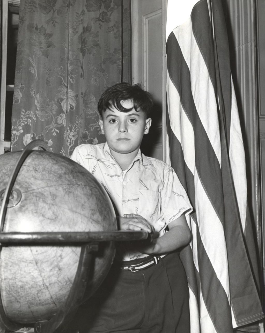 Miniature of Boy standing with globe and U.S. flag