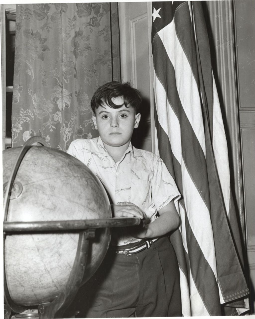 Miniature of Boy standing with globe and U.S. flag