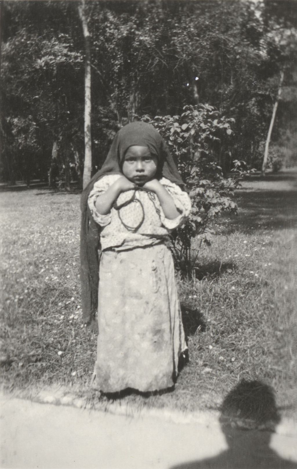 Miniature of Young girl with scarf on her head standing in park