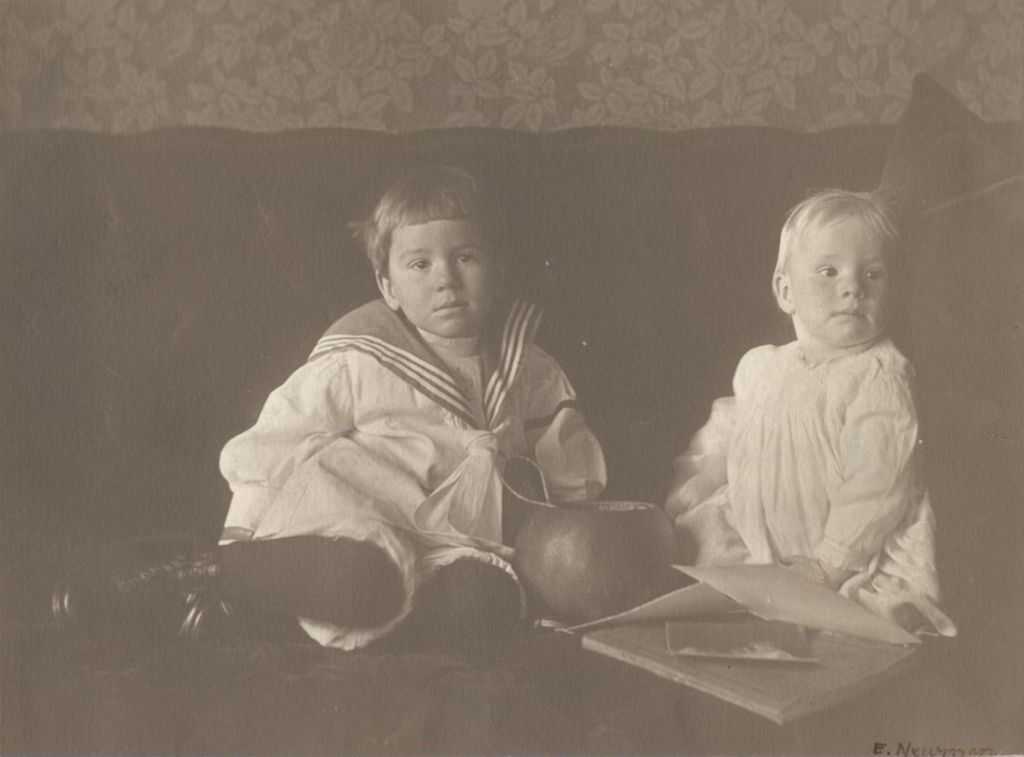 Two young boys (Frederick and William Deknatel), sitting on couch
