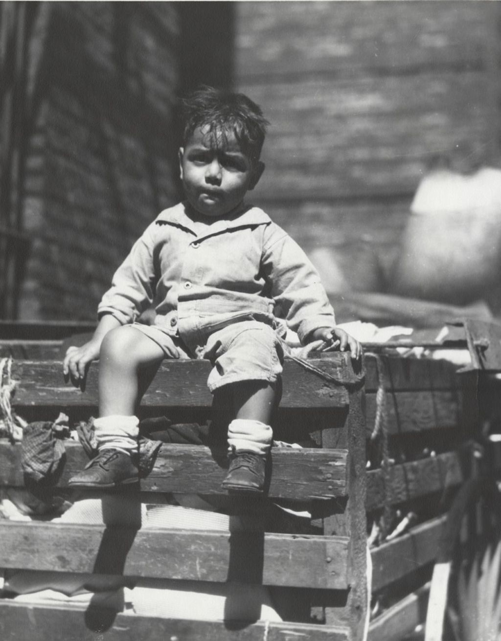 Miniature of Boy sitting on large wooden cart