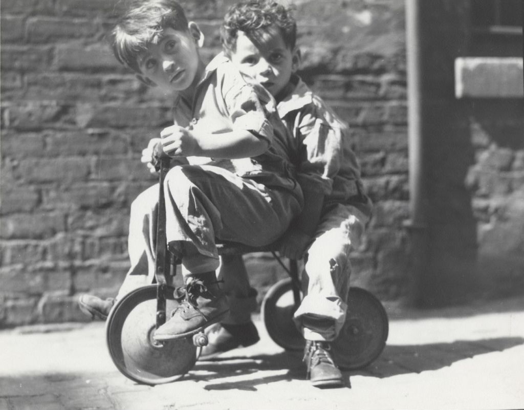 Two young boys on tricycle