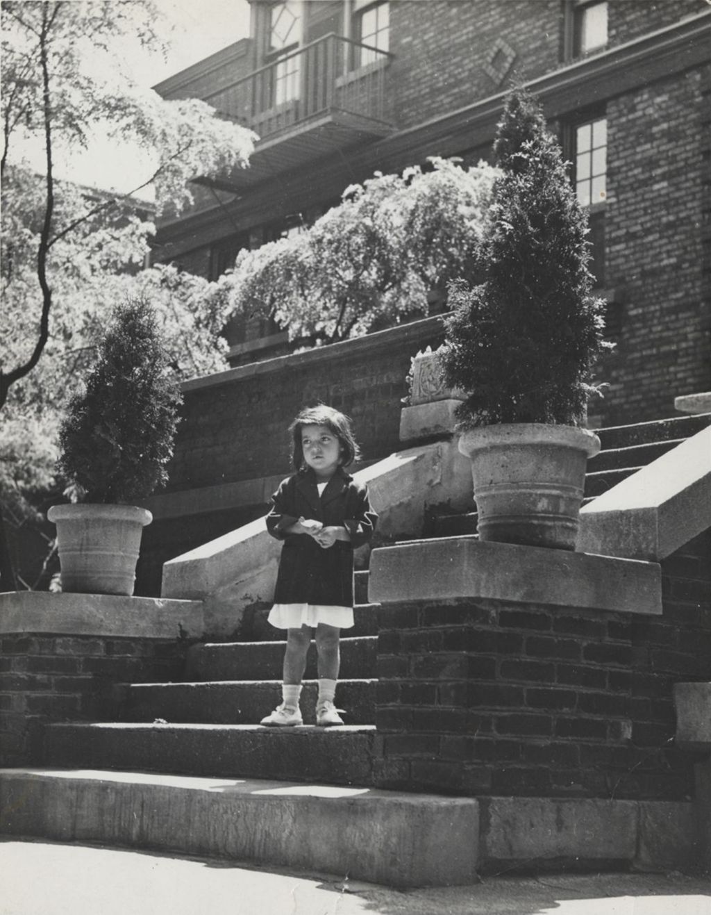 Miniature of Girl (Lupe Ramos) standing on steps behind Hull-House Dining Hall