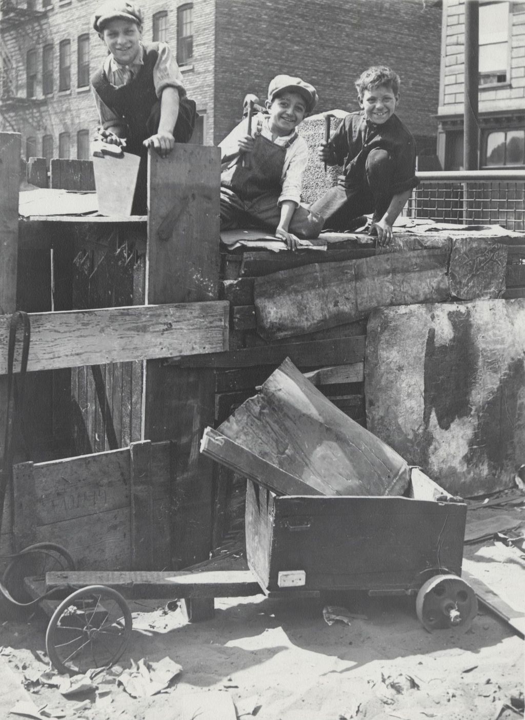 Miniature of Three boys with tools constructing a club house in the Hull-House neighborhood