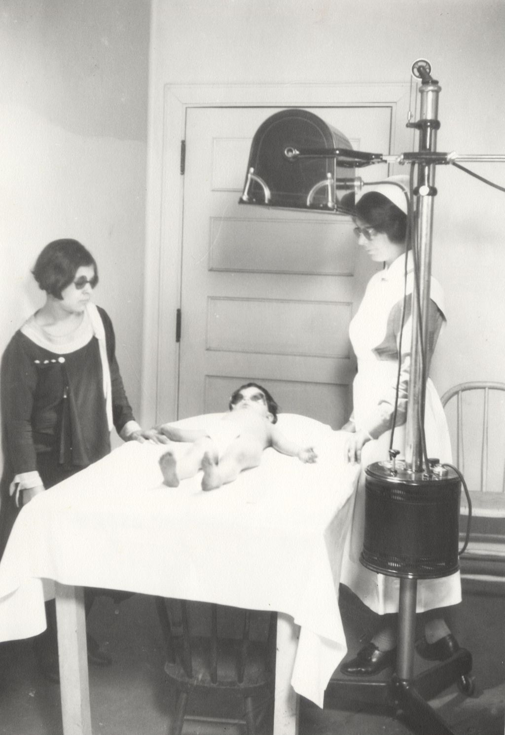 Miniature of Small child gets sunlamp treatment to prevent rickets from the Infant Welfare Society in the Mary Crane Nursery