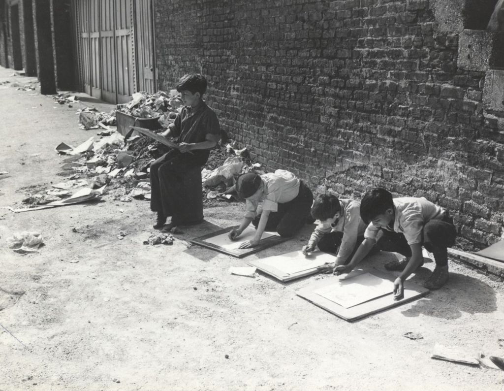 Miniature of Boys drawing in garbage strewn alley