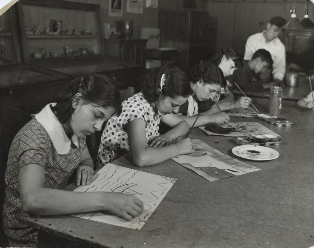 Children painting and drawing in art class
