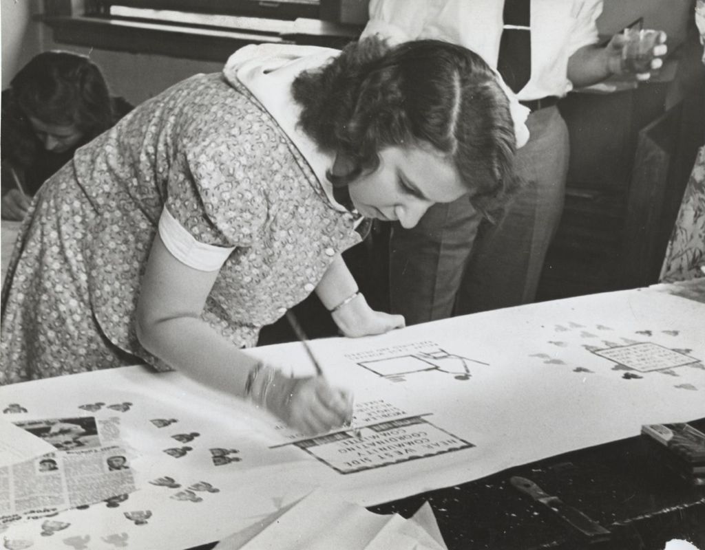 Woman completing sign at drafting table