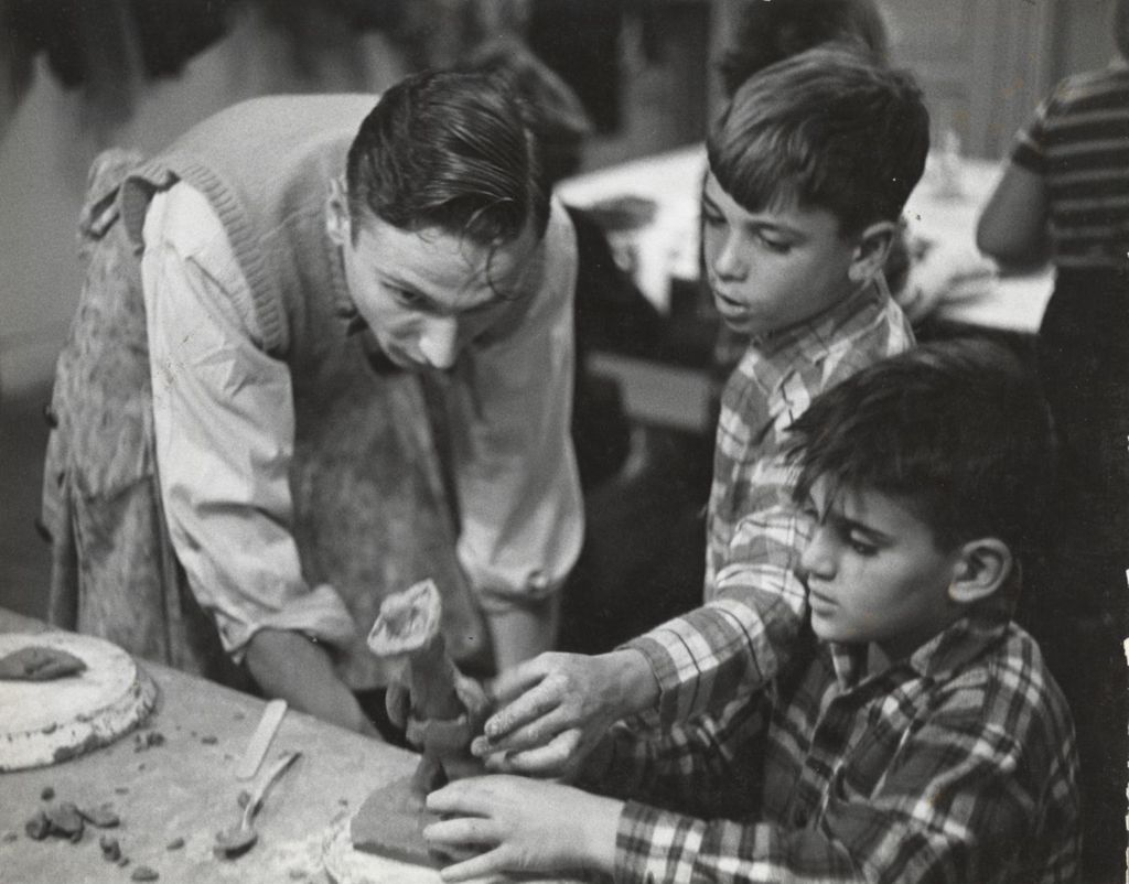 Miniature of Boys showing clay model to teacher