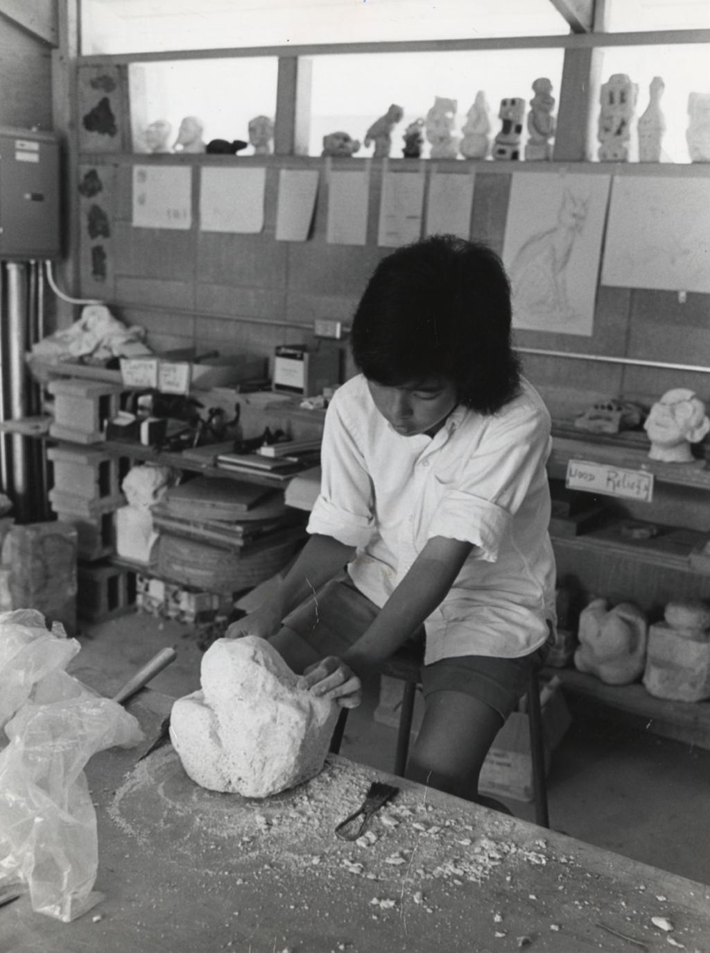Miniature of Child working with stone in sculpture class