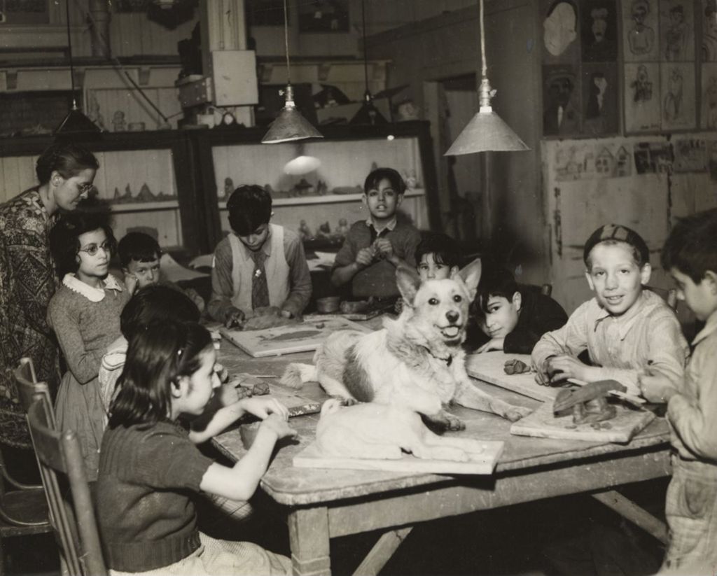 Miniature of Children in clay modeling group with dog on table