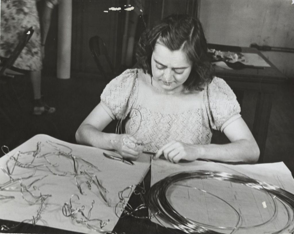 Woman creating wirework