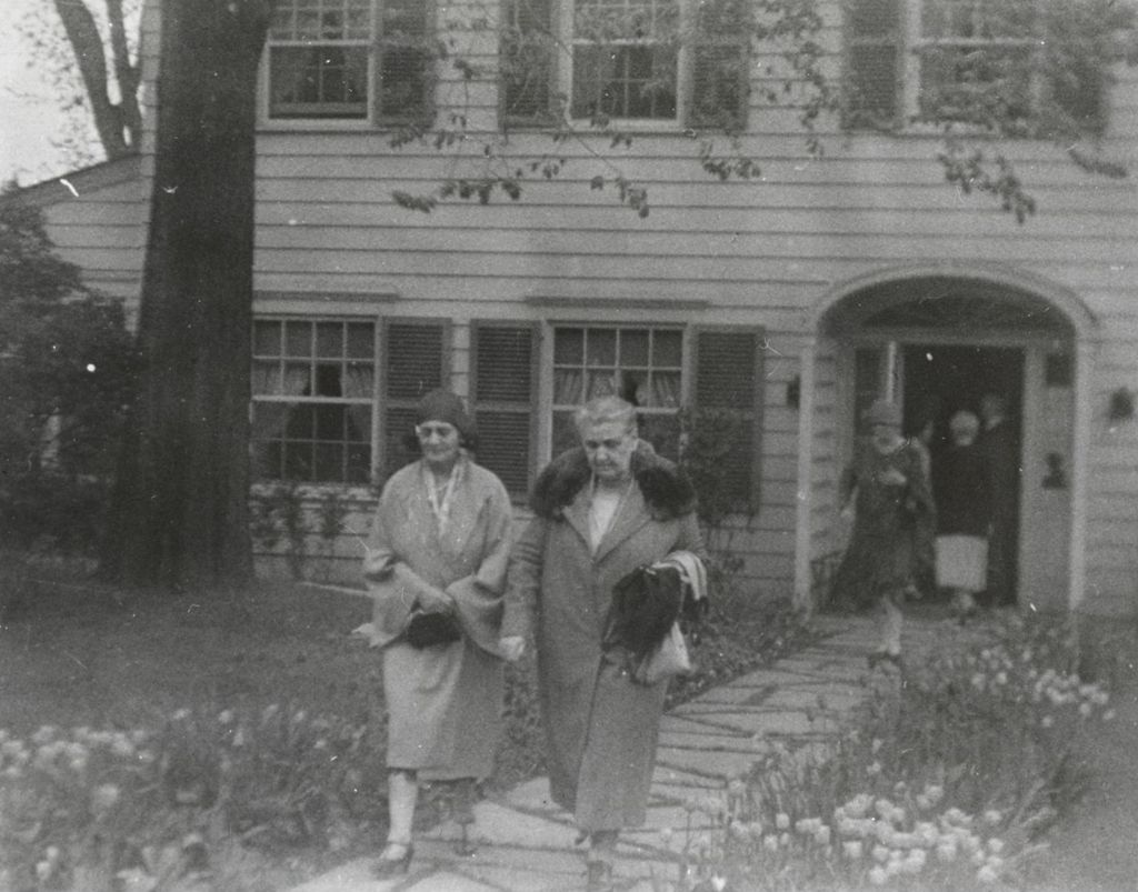 Jane Addams and Mary Rozet Smith leaving a Lilac Cottage at Bowen Country Club during Hull-House 40th Anniversary celebration