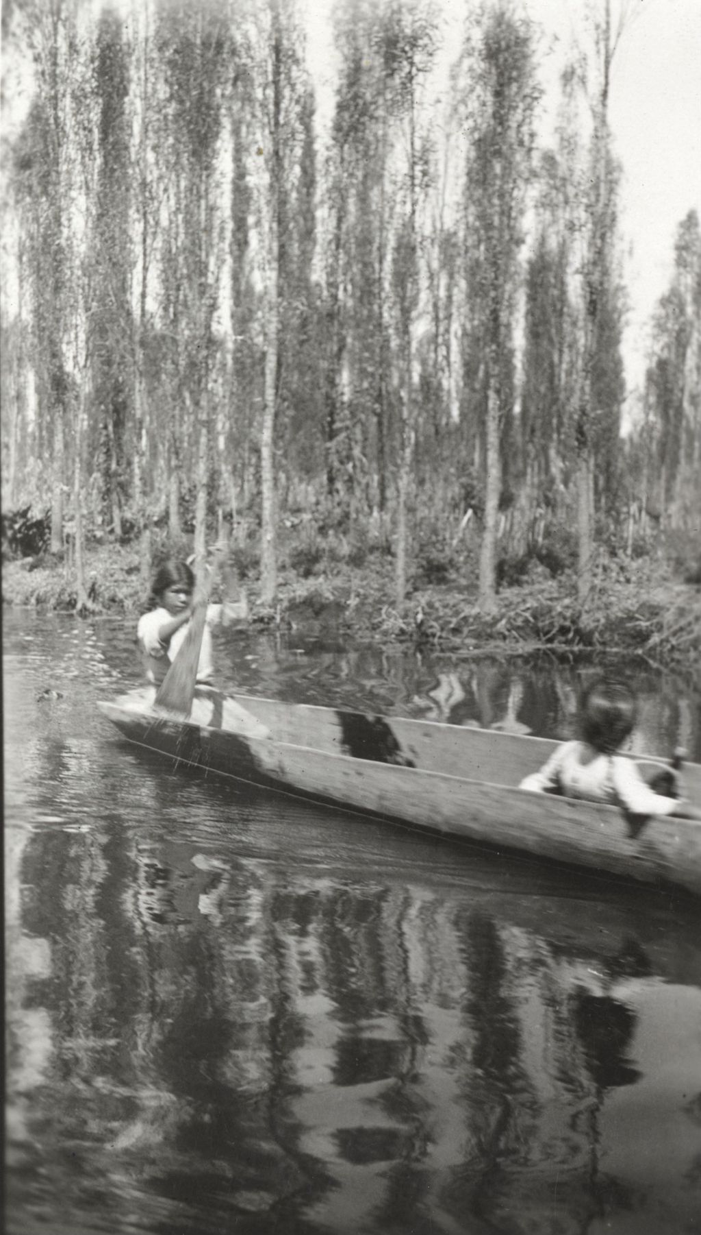 Two people in a dugout canoe photographed on Jane Addams' trip to Mexico