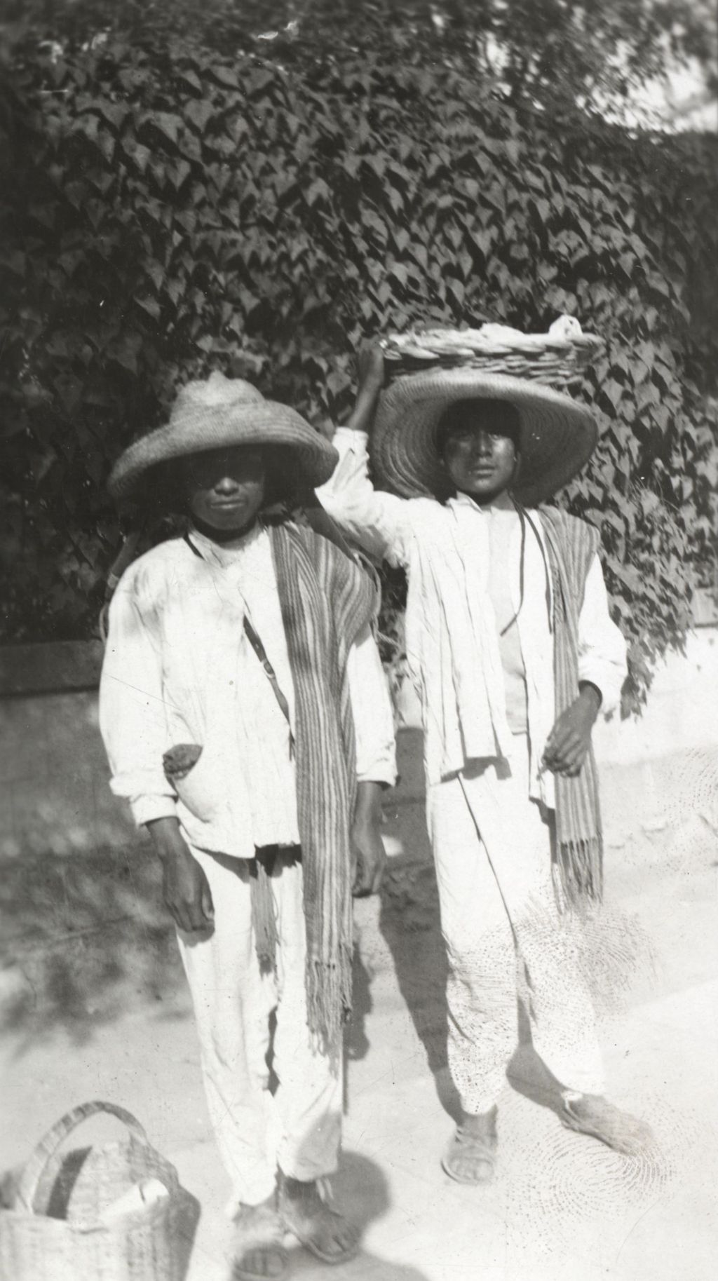 Two Mexican men with baskets photographed on Jane Addams' trip to Mexico