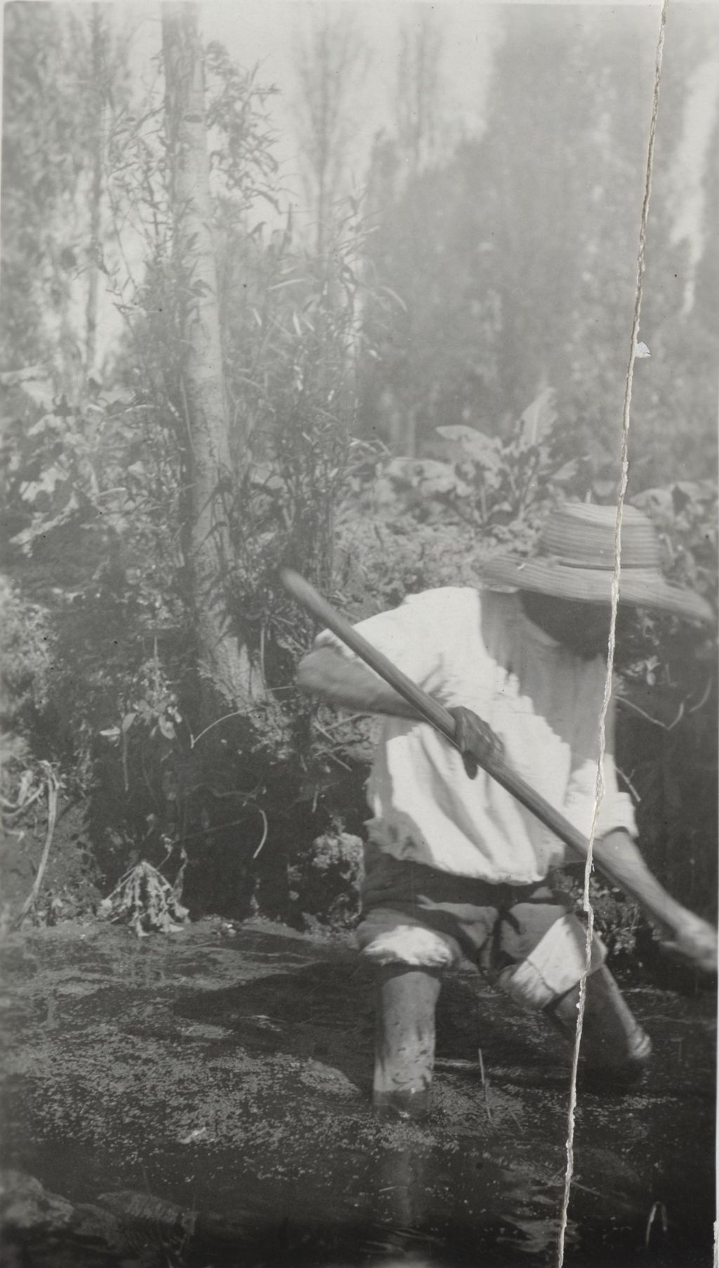 Man working in swampy water photographed on Jane Addams' trip to Mexico