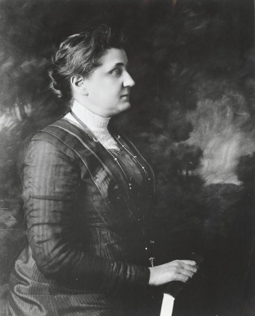 Profile portrait of Jane Addams holding a book
