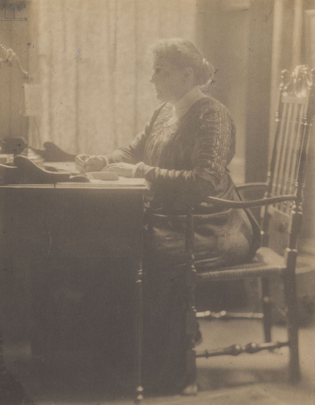 Jane Addams writing at a desk