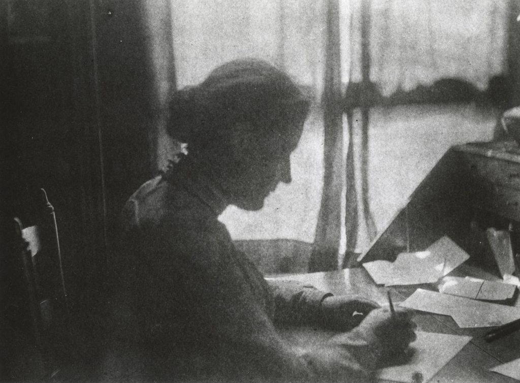Miniature of Jane Addams writing at a desk