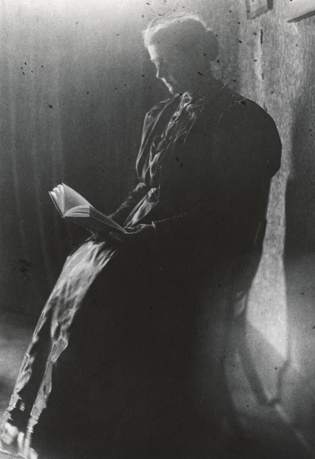 Portrait of Jane Addams reading a book